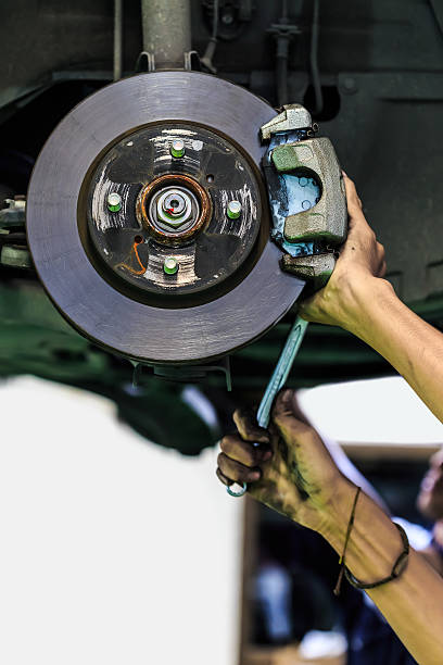 istock Hands of a mechanic install brake lining 184439512
