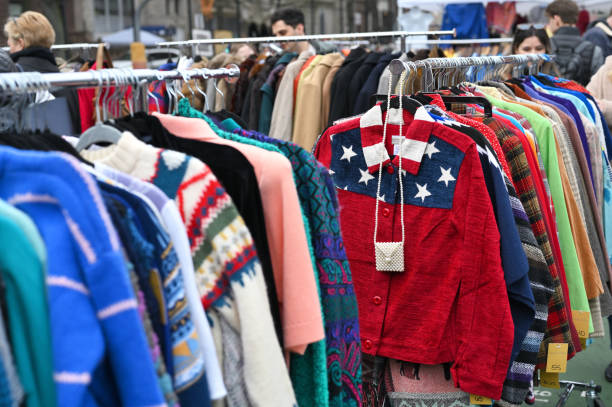 New York, USA - February 19, 2023: Clothes on a racks for sale at flea market in Manhattan, New York, United States