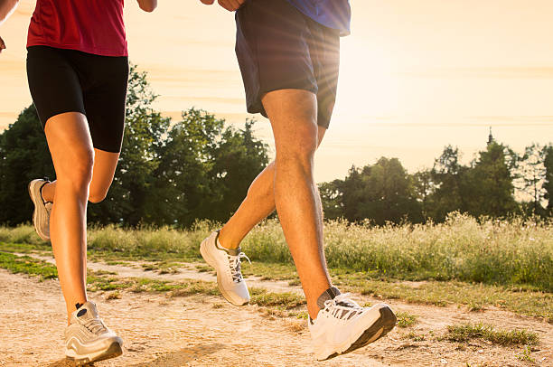 istock Young Couple Jogging in Park 184441381