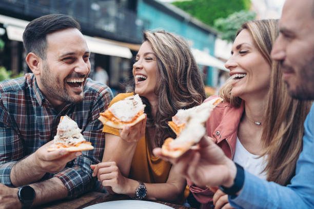 istock Happy friends eating pizza together 1844424847