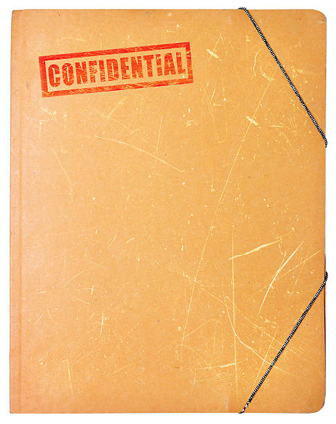 A worn folder with the word confidential written on it Confidential folder for papers isolated on white background old file folder stock pictures, royalty-free photos & images