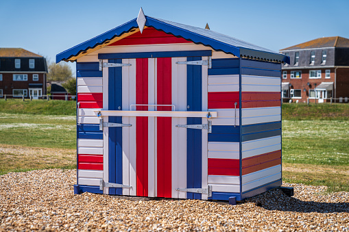 Littlestone, Kent, England - May 08, 2022: A beach hut in the colors of the Union Jack