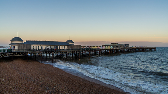Hastings, East Sussex, England, UK - May 11, 2022: Evening mood on the beach, with the pier in the background