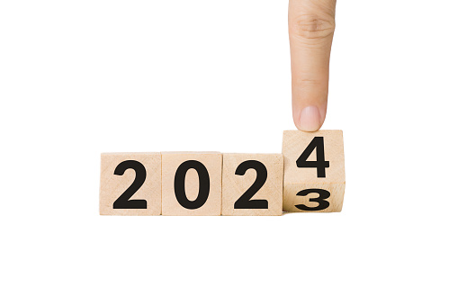 hand, finger flipping wooden cube block from year 2023 turn to year 2024. beginning and start of the new year 2024. Preparation for new year ,life, business, plan, goals, target and strategy concept.
