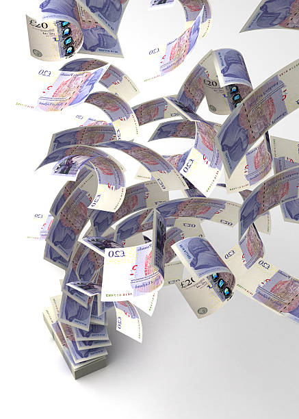 istock Flying British pounds from a stack of money 184450454