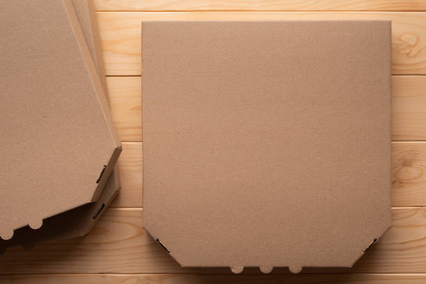 istock Pizza closed carton box on natural wooden table flat lay mockup with copy-space 1844512743