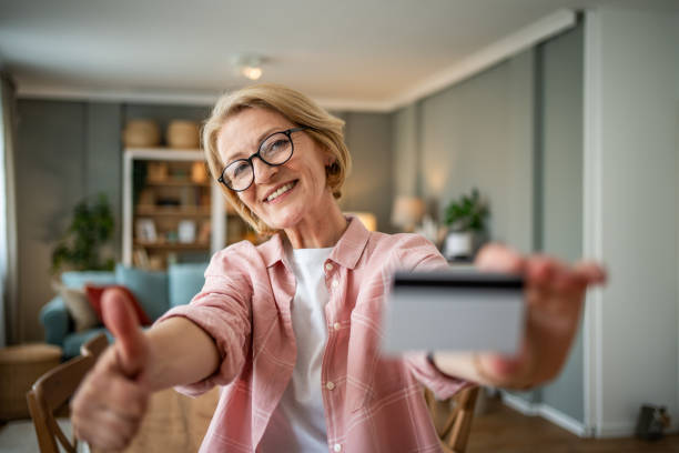 istock Mature woman using digital tablet and payment card for online shopping 1844514336