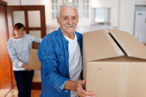 istock Senior couple carrying boxes into new home on Moving Day 1844516459