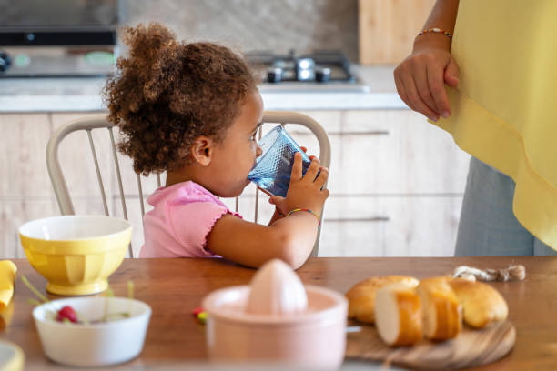 istock Child Hydrating During Family Breakfast Time 1844516991