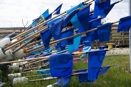 Fishing port and marina in Kąty Rybackie in Poland, the Pomeranian Voivodeship, Nowy Dwór County, Sztutowo commune. Buoys with flags for fishing nets.