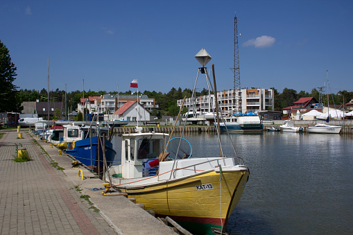 Fishing port and marina in Kąty Rybackie in Poland, the Pomeranian Voivodeship, Nowy Dwór County, Sztutowo commune. Fishing boats, fishing equipment, yachts and tourist boats in the port. Boats moored at the port quay.