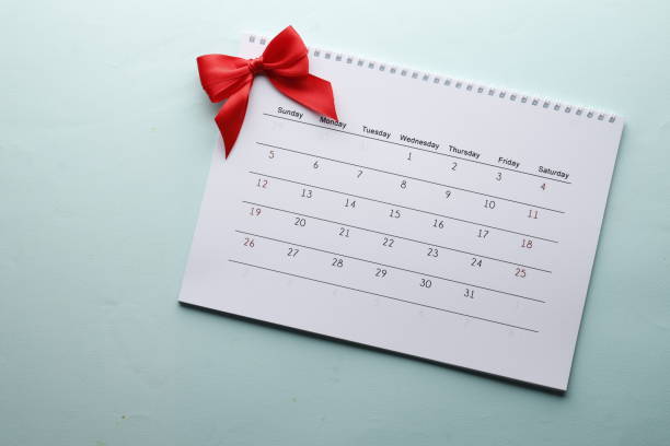 istock Calendar with a red bow on a blue background. Important date. Place for text. Planning concept. 1844539350