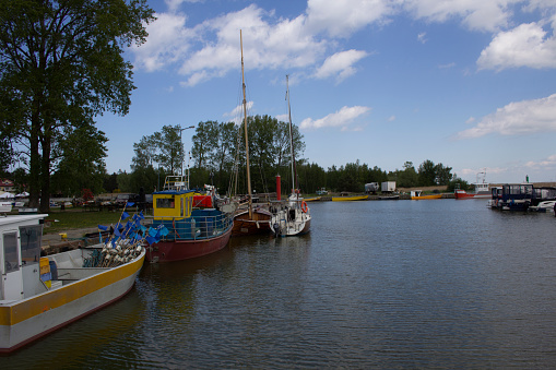 Fishing port and marina in Kąty Rybackie in Poland, the Pomeranian Voivodeship, Nowy Dwór County, Sztutowo commune. Fishing boats, fishing equipment, yachts and tourist boats in the port. Boats moored at the port quay.