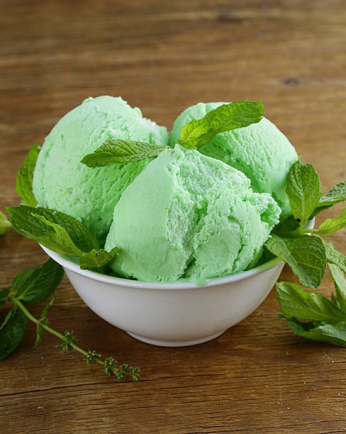 balls mint ice cream with fresh green herb