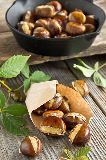 istock Roasted chestnuts on wooden background 184457176