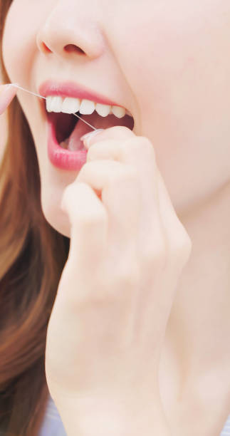 istock asian female flossing clean teeth 1844586770