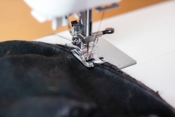 istock Sewing machine needle and black cloth closeup 1844593629