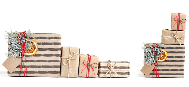 Many Kraft stylish christmas gift boxes isolated on white background