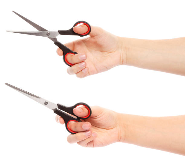 istock Hand holds scissors isolated on white background. Scissors in hand 1844616667