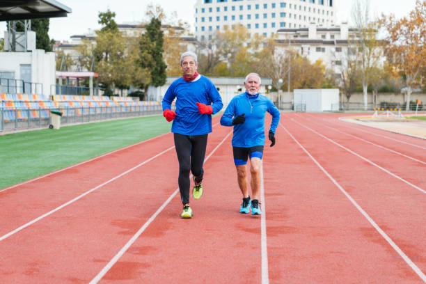 istock Senior Caucasian Runners Exercising Together on Track 1844627105