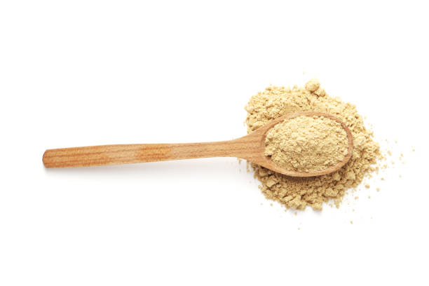 istock Dry ginger in a wooden spoon isolated on white background 1844641564