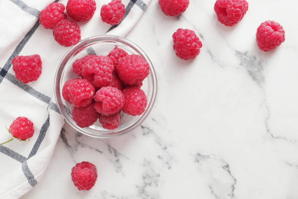 istock composition of ripe raspberries in a bowl on a textured background 1844669883