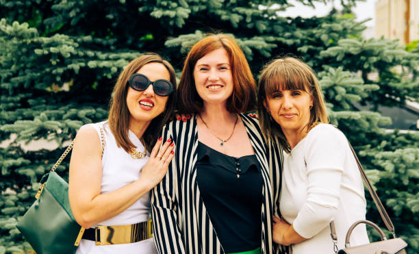 istock Beautiful refined cheerful three women in evening dresses. 1844674051