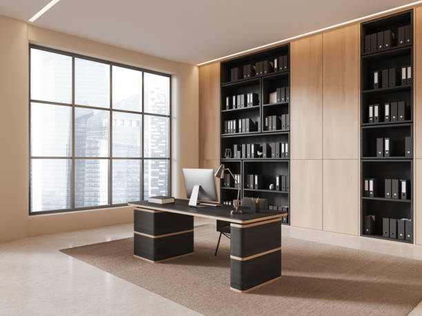 istock Modern office interior with work desk, pc desktop and shelf near window 1844679769
