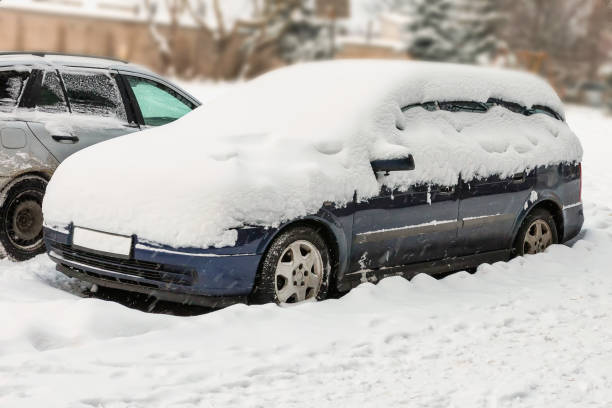 istock Car covered with snow in the yard 1844681413