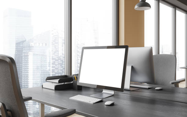 istock Stylish workspace interior with pc desktop on desk with mock up display, window 1844700156