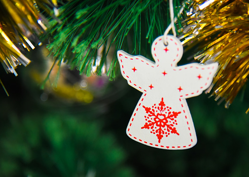 Christmas wooden decoration in the form of an angel on a Christmas tree
