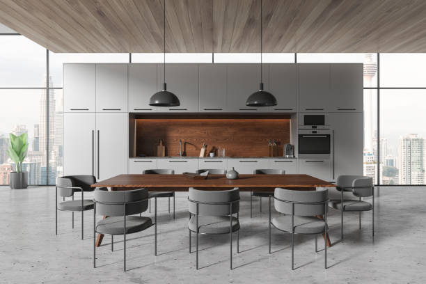 istock Grey home kitchen interior with eating table, cooking shelves and window 1844700446