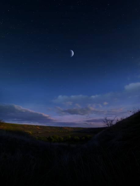 istock A crescent moon in the sky after sunset. 1844714868