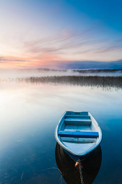 istock Tranquil Sunrise over Misty Lake with Blue Sky and Clouds 1844729859