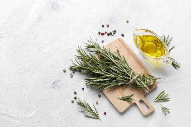 istock Flat lay composition with rosemary, spices, oil on white concrete background, space for text 1844731399