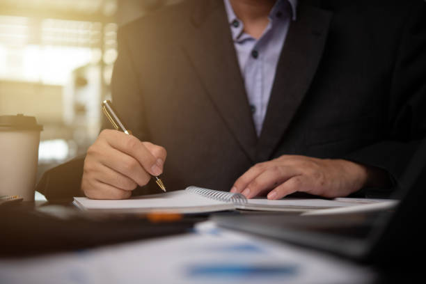 istock man hands with pen writing on notebook in the office.learning, education and work.writes goals, plans, make to do and wish list on desk. 1844793665