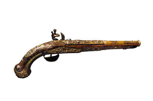 An antique flintlock pistol with beautiful designs and decorations. Isolated on a white background.
