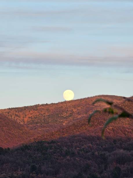 istock Moonlight and sunset over the mountain 1844849075