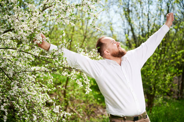 istock Man allergic enjoying after treatment from seasonal allergy in front of blossom tree at spring. 1844856474