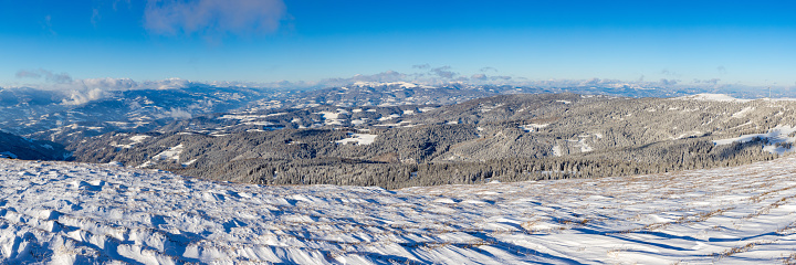 Panoramic view of beautiful winter mountain landscape with fresh snow and blue sky