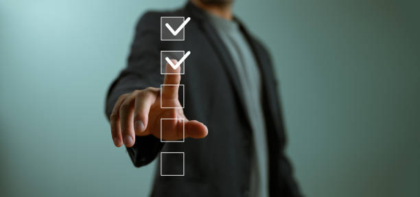 istock Check list, Businessman Take an assessment, questionnaire, evaluation, online survey exam Choosing the right answer in the exam, filling out an online survey form. Answer the test questions. 1844886555