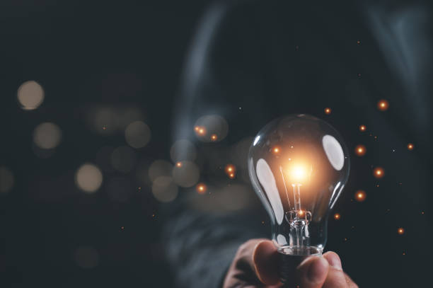 istock Businessman holding illuminated lightbulb, idea, innovation and inspiration with glowing light, smart intelligent creativity with bulbs, Motivation and innovation concept. New idea business start up. 1844888120