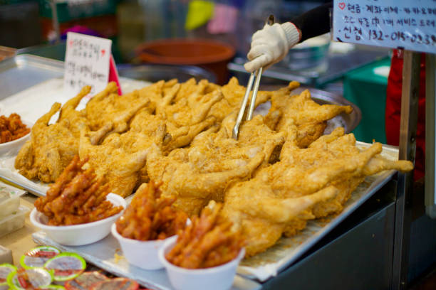 Ulsan, South Korea - July 30, 2023: Golden fried chicken tempts passersby at a traditional Korean market, a testament to the country's love for this crispy, flavorful delicacy.