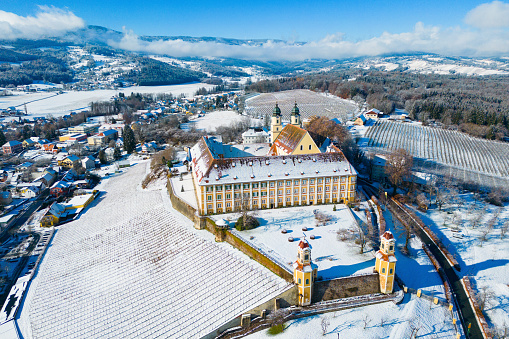 Stainz, Austria - November 26, 2023: Historic castle of Stainz surrounded by beautiful winter landscape