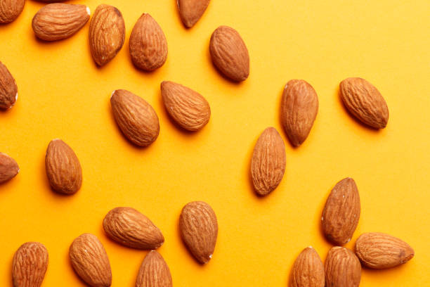 istock Almond on orange background. Top view. 1844928377