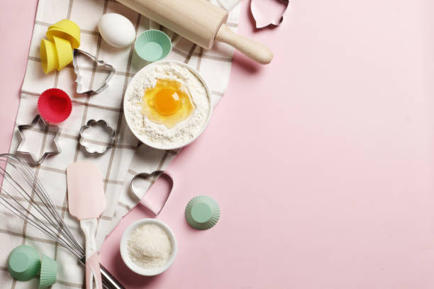 istock Baking utensils and ingredients.  Rolling pin, sugar sprinkling, whisk with cookie mold on a pink background. Baking concept. Place for text. 1844944202