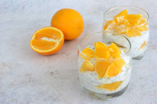 istock dessert with chia pudding and chopped orange in drinking glasses 1844946338