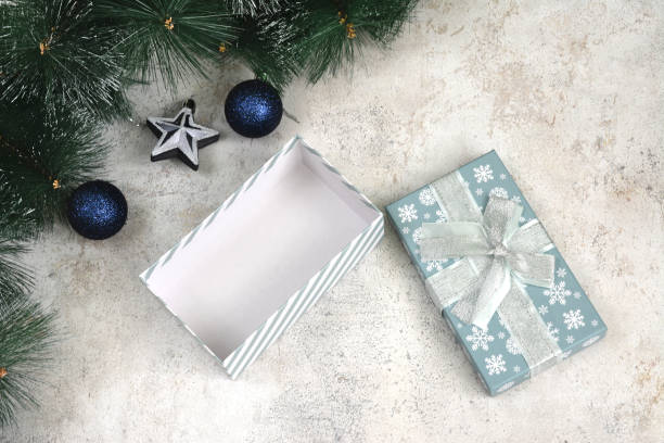 istock open gift box with spruce branches and blue spheres top view 1844948455