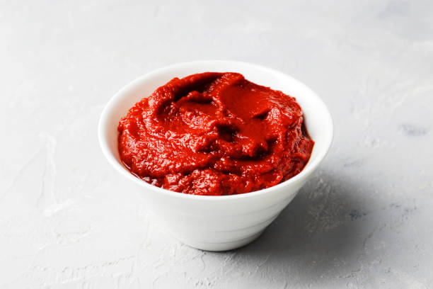 istock tomato sauce in a gravy boat on a marble background. 1844955526