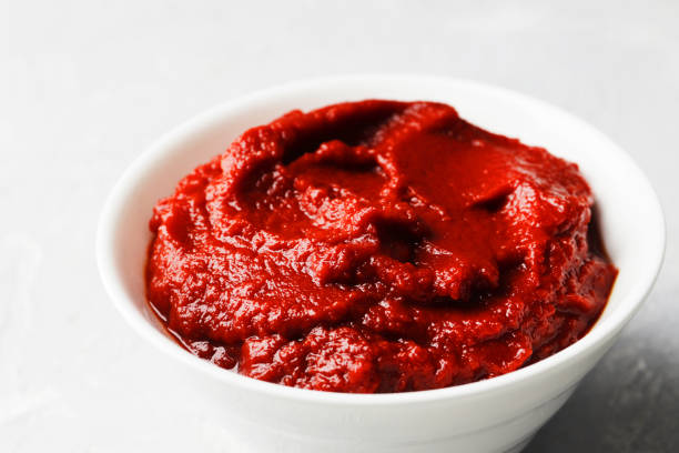 istock tomato sauce in a gravy boat on a marble background. 1844955538